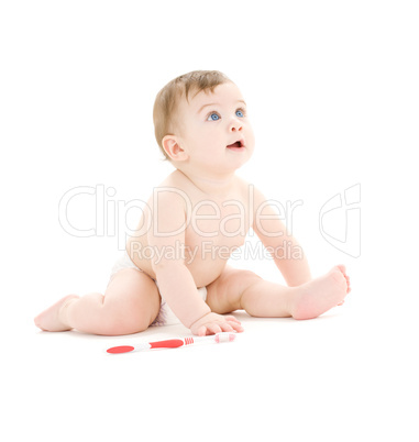 baby boy in diaper with toothbrush