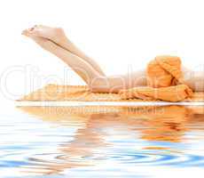 long legs of relaxed lady with orange towel