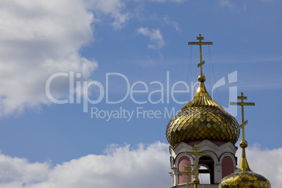Church dome with cross on sunny sky