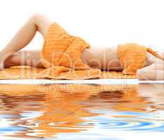 torso of relaxed lady with orange towels