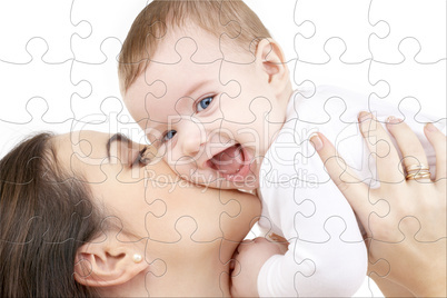 laughing baby playing with mother puzzle