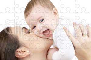 laughing baby playing with mother puzzle