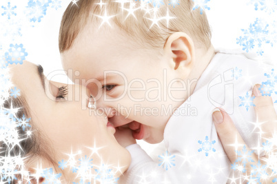 happy mother kissing baby boy