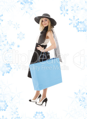 blond in retro hat with blue shopping bag