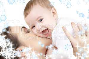 laughing baby playing with mother