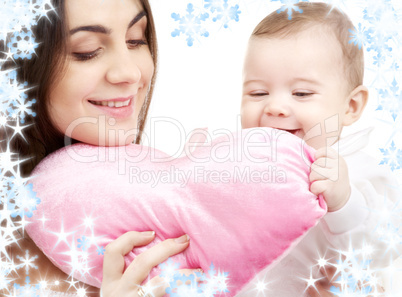 baby and mama with heart-shaped pillow