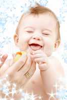 laughing baby boy in mother hands with rubber duck