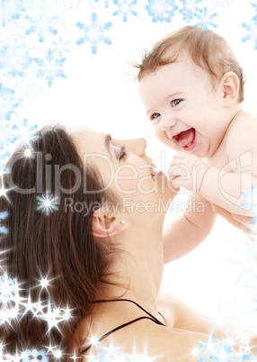 laughing blue-eyed baby playing with mom