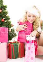 santa helper girl with gifts and christmas tree