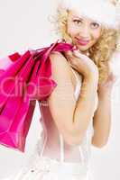 cheerful santa helper girl with shopping bags