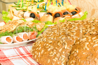 Meat, canape and Bread with seeds on table