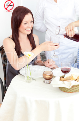 Smiling girlfriend at the restaurant with her boyfriend