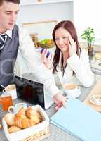 Couple of businesspeople having breakfast in the kitchen