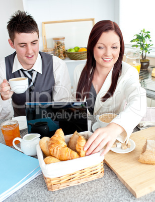 Caucasian couple of businesspeople using a laptop during their b