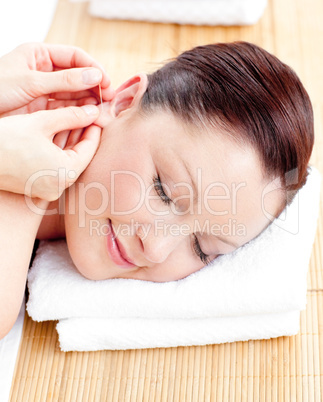 Close-up of a relaxed woman receiving a head massage