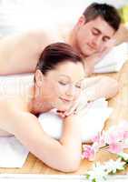 Merry young couple receiving a back massage