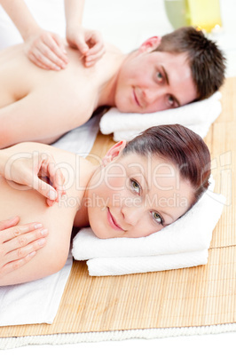 Kind young couple receiving a back massage