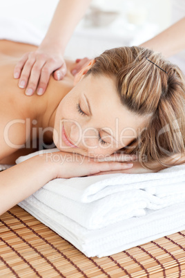 Positive young woman having a back massage