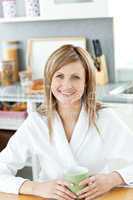 Charming woman drinking coffee in the kitchen