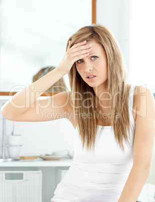 Attractive woman having a headache in the bathroom