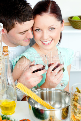 Loving young couple cooking spaghetti in the kitchen