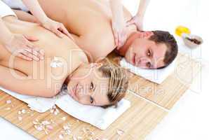 Enamored young couple enjoying a back massage