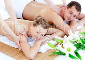 Charming young couple enjoying a back massage