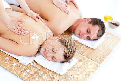 Positive young couple enjoying a back massage