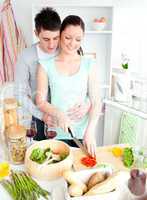 Loving couple preparing a salad in the kitchen