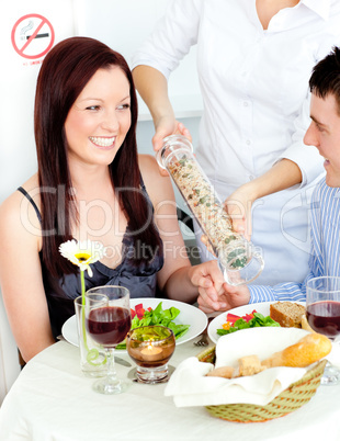 Cheerful young couple dining at the restaurant