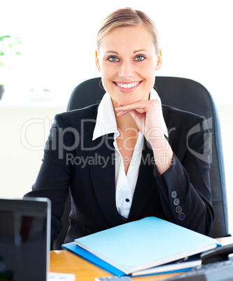 Sophisticated caucasian businesswoman smiling at the camera in h