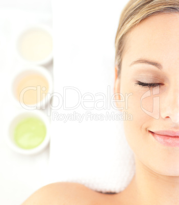 Portrait of a charming young woman lying on a massage table