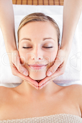 Happy woman receiving a head massage