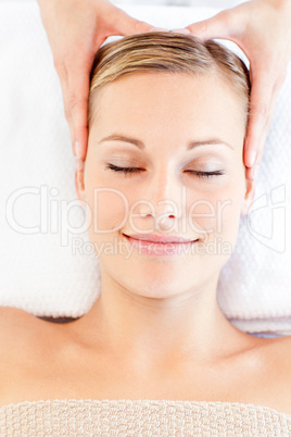Young relaxed woman receiving a head massage