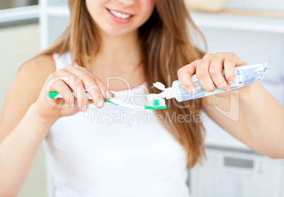 Close-up of a blissful caucasian woman holding a toothbrush in t