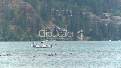 amphibious aircraft taxis on lake