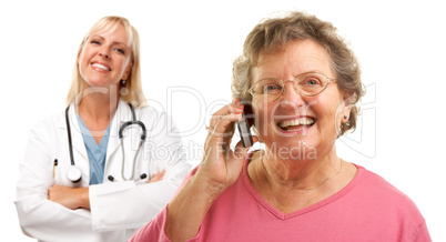 Happy Senior Woman Using Cell Phone with Female Doctor Behind