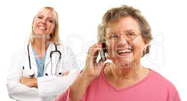 Happy Senior Woman Using Cell Phone with Female Doctor Behind