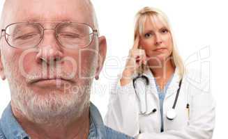 Concerned Senior Man and Female Doctor Behind
