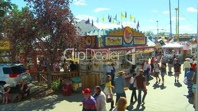 crowds at fair midway, candy stand