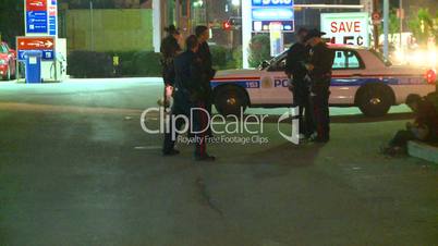 Police car arriving, police and suspects on a late Saturday night, Canada.