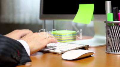 HD: Businessman typing on computer keyboard at office