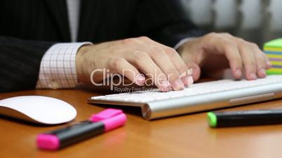 Office manager typing on computer keyboard