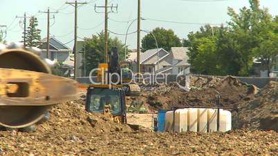 construction, backhoe and bulldozers long lens