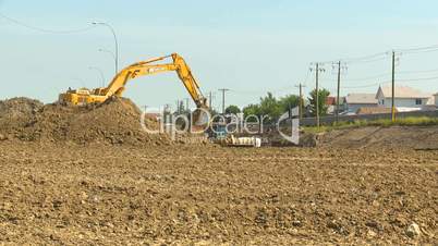 wide shot, construction backhoe bulldozers