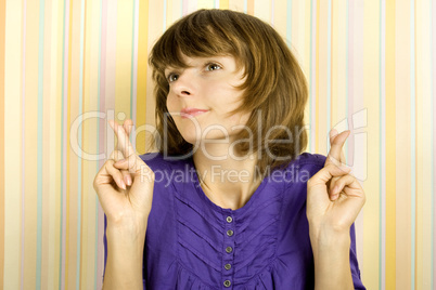 Young woman with fingers crossed