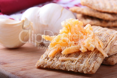 Wheat crackers with grated cheese.