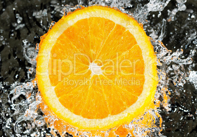 fresh orange in streaming water