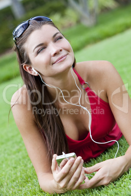 Beautiful Brunette Woman laying Down Listening to MP3 Player