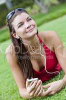 Beautiful Brunette Woman laying Down Listening to MP3 Player